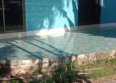 Outdoor pool area with blue building façade