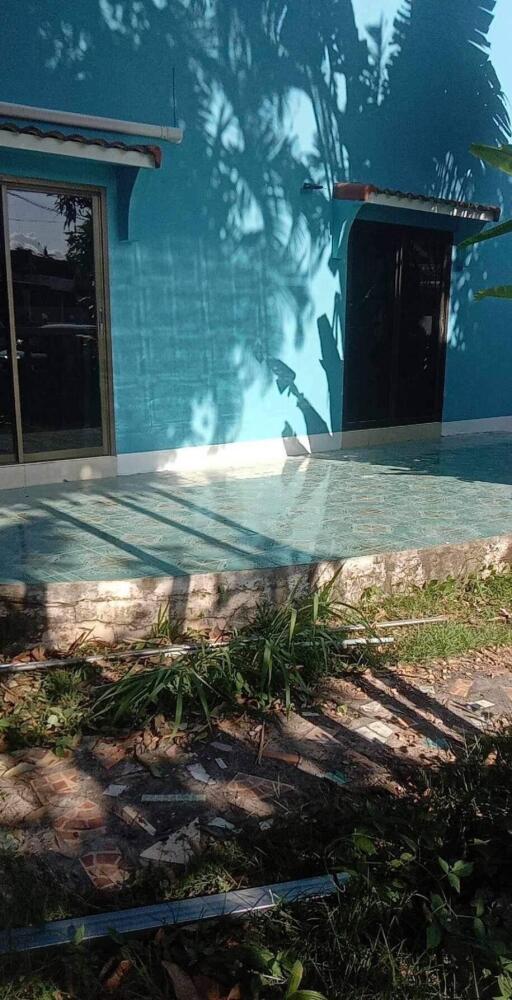 Outdoor pool area with blue building façade