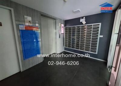 Lobby area with mailboxes and elevator access