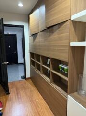 Stylish minimalist hallway with wooden storage units