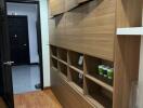 Stylish minimalist hallway with wooden storage units