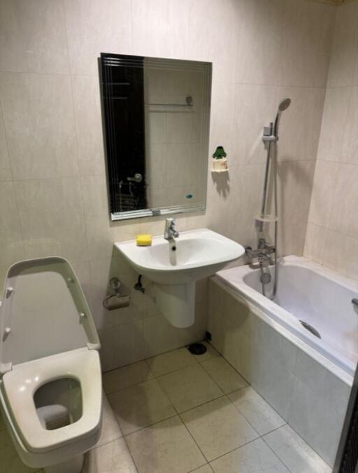 Bathroom with toilet, sink, mirror, and bathtub with shower
