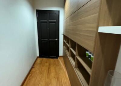 Hallway with wooden flooring and built-in storage