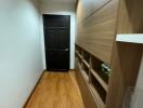 Hallway with wooden flooring and built-in storage