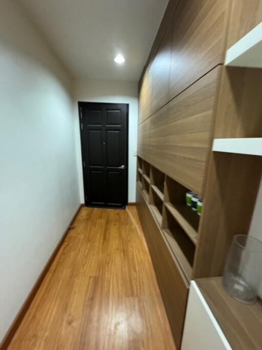 Hallway with wooden flooring and built-in storage