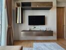 Modern living room with wall-mounted TV and stylish cabinets