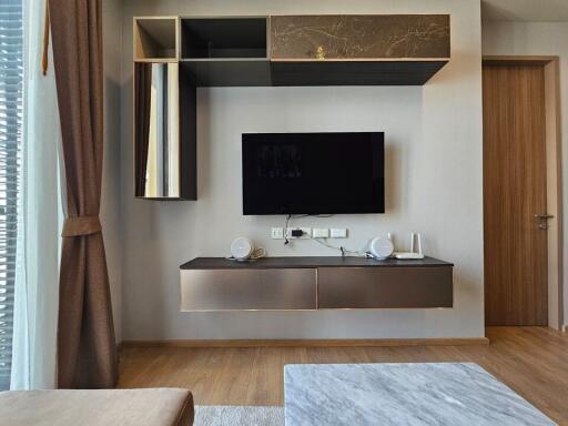 Modern living room with wall-mounted TV and stylish cabinets
