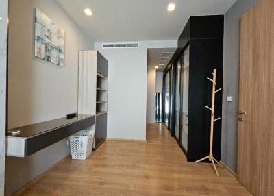 Modern hallway with wooden flooring and storage