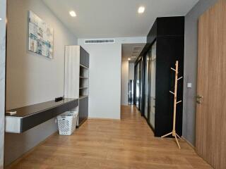 Modern hallway with wooden flooring and storage