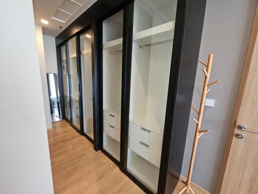 Spacious walk-in closet with glass door wardrobes