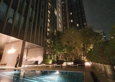 night view of a high-rise building with a swimming pool