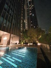 night view of a high-rise building with a swimming pool