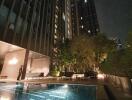 night view of a high-rise building with a swimming pool