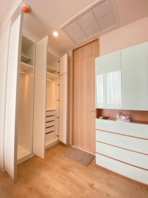 Bright and spacious bedroom closet with open and closed storage options.