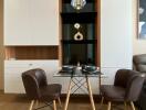 Modern dining area with a glass table and two chairs