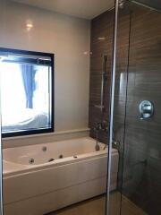 Modern bathroom with bathtub and glass shower enclosure