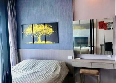 Modern bedroom with view of bed, painting, dressing table, and mirror