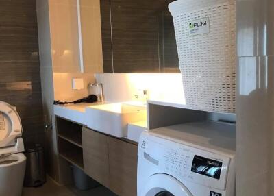 Modern laundry room with washing machine and storage