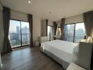 Modern bedroom with large windows and city view