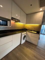 Modern kitchen with black countertops and white cabinets