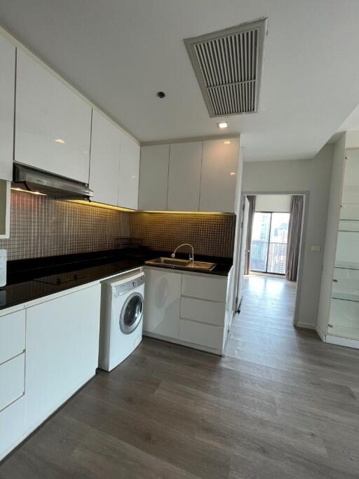 Modern kitchen with integrated appliances and wooden flooring