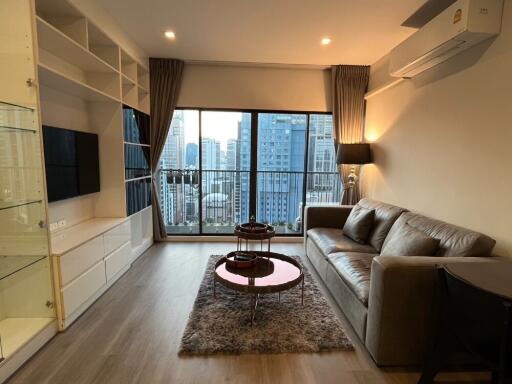 Modern living room with large windows and city view