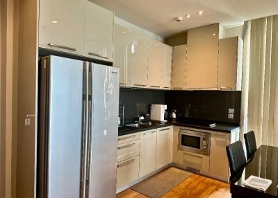 Modern kitchen with stainless steel appliances and glossy cabinets