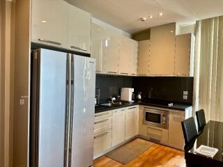 Modern kitchen with stainless steel appliances and glossy cabinets