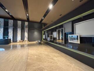 Modern lobby exhibiting artistic decor with elegant lighting and marble flooring