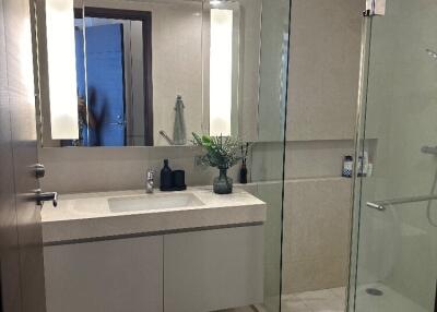 Modern bathroom with a glass shower and large mirror