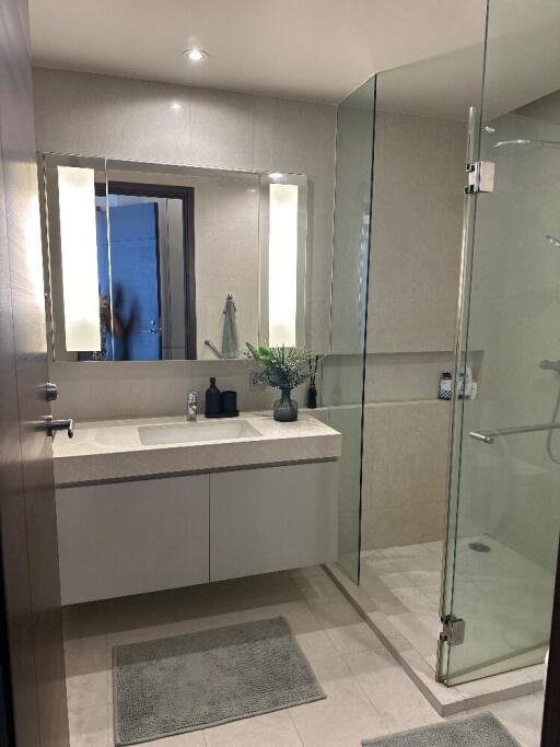 Modern bathroom with a glass shower and large mirror