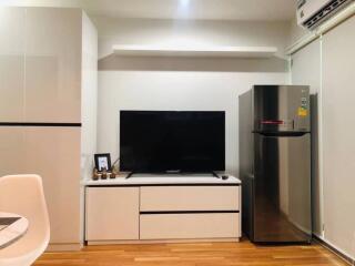 Modern living space with TV and refrigerator