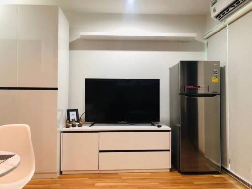 Modern living space with TV and refrigerator