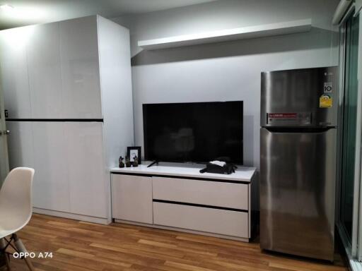 Minimalist living room with entertainment center and fridge