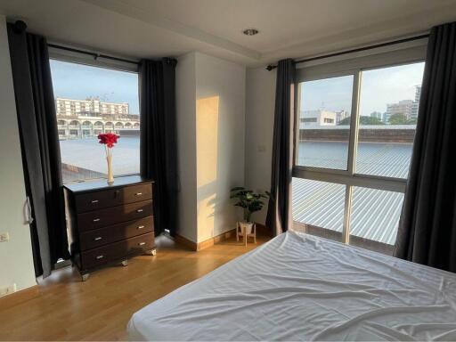 Bedroom with large windows and city view