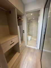 Walk-in closet with access to modern bathroom