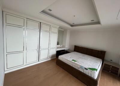 Spacious bedroom with built-in wardrobe and bed