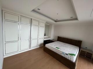 Spacious bedroom with built-in wardrobe and bed