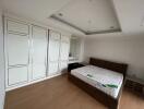 Spacious bedroom with built-in wardrobe and bed