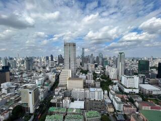 Aerial view of a city skyline with tall buildings and a cloudy sky