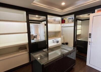 Spacious walk-in closet with shelves and mirrored doors