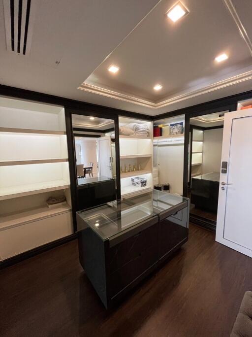 Spacious walk-in closet with shelves and mirrored doors