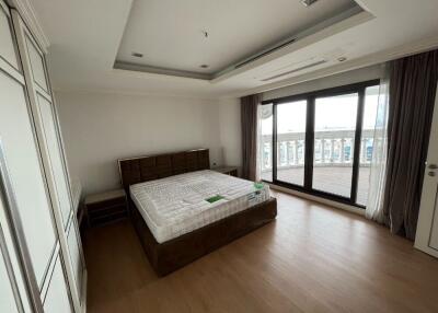 Spacious bedroom with balcony access and large windows