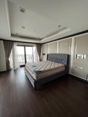 Spacious bedroom with large windows and bed