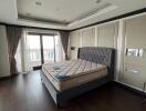 Spacious bedroom with large windows and bed