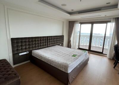 Spacious bedroom with large window and balcony access