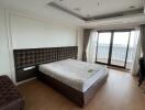 Spacious bedroom with large window and balcony access