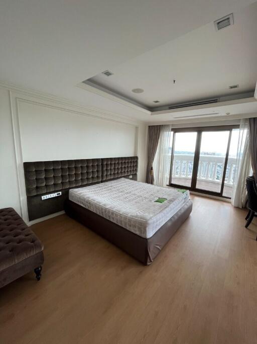 Spacious bedroom with large window and balcony access