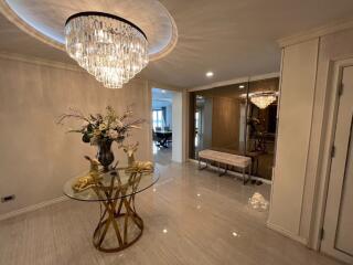 Elegant entryway with chandelier and mirrored wall