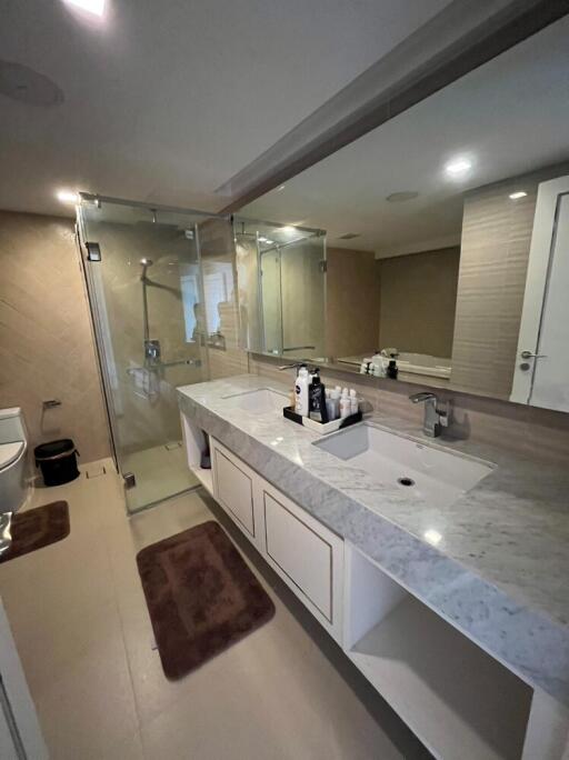Modern bathroom with glass shower and marble countertop